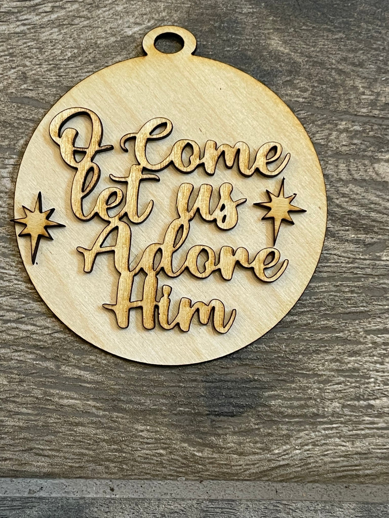 A Little August Ranch DIY Christmas Tree Ornament Wood Blanks - Christian Christmas Tree Ornaments - Nativity Ornament featuring a wooden nativity scene, with the words "come let us adore him" elegantly engraved.