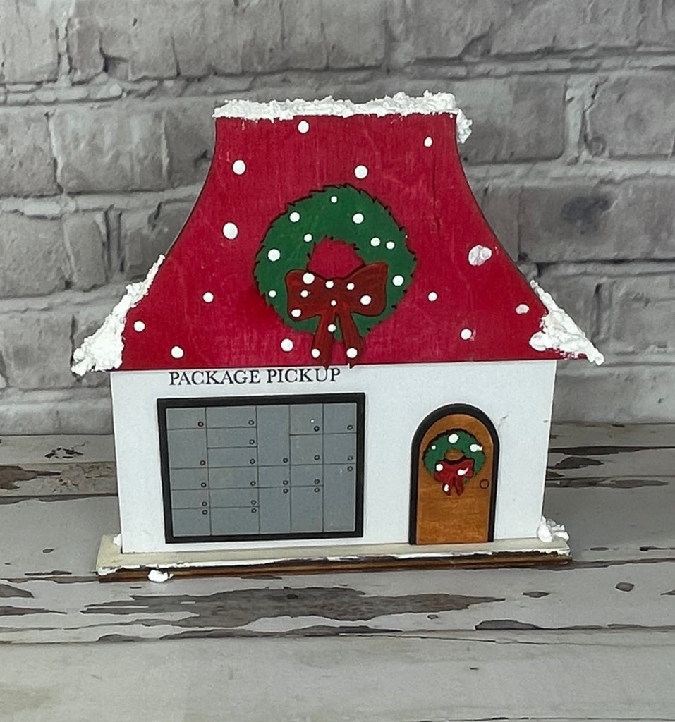 A wooden house with a Christmas Village Self Standing Double sided Pieces - POST OFFICE - Winter Village Wood Blanks on it, made by Little August Ranch.
