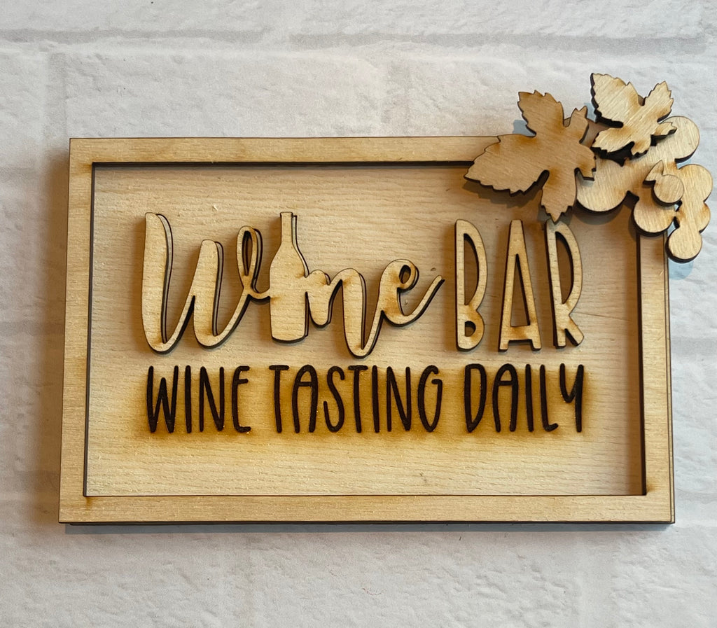 A wooden sign that says Little August Ranch's DIY Wine Tiered Tray - Wine and Cheese Tiered Tray Decor- Uncork Tiered Tray - Paint it Yourself kit for wood items.