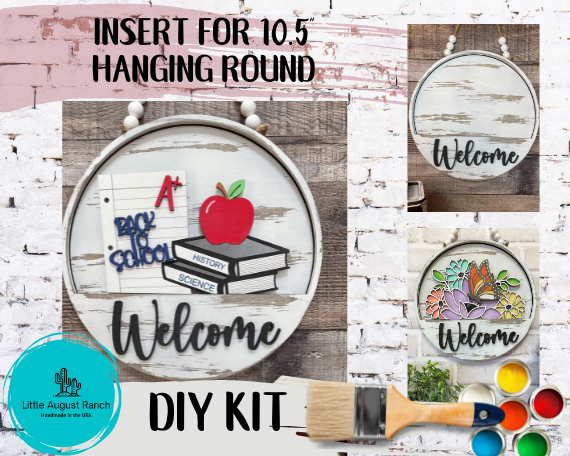 A welcome DIY kit with an image of a school and a welcome sign. The Little August Ranch DIY Interchangeable Door Hanger - School Insert for Interchangeable - Paint it Yourself kit includes an interchangeable door hanger/interior sign.