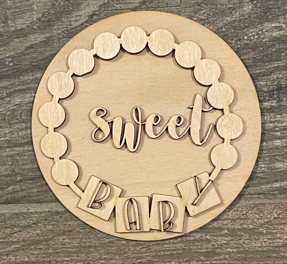 An adorable wooden plaque with the words "sweet baby" on it, perfect for Little August Ranch's Baby Tiered Tray DIY Kit - Baby Shower, Gender Reveal Wood Blanks enthusiasts or those who love to accessorize their tiered tray with charming wood items.