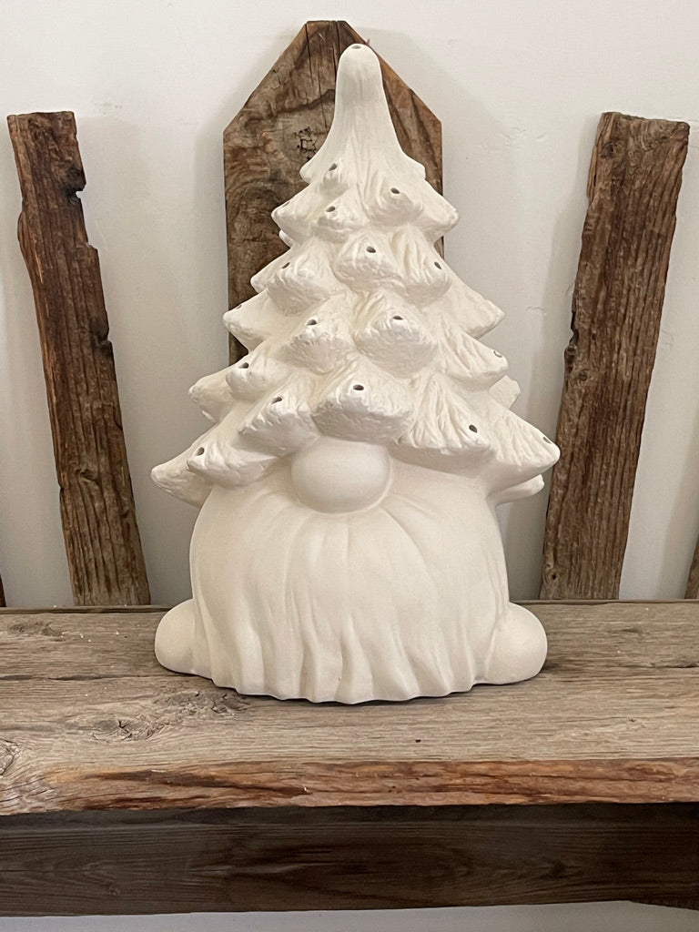 A Gare Gnome Christmas Tree - Kit Paint at Home sitting on a wooden shelf, perfect for a Christmas collection.