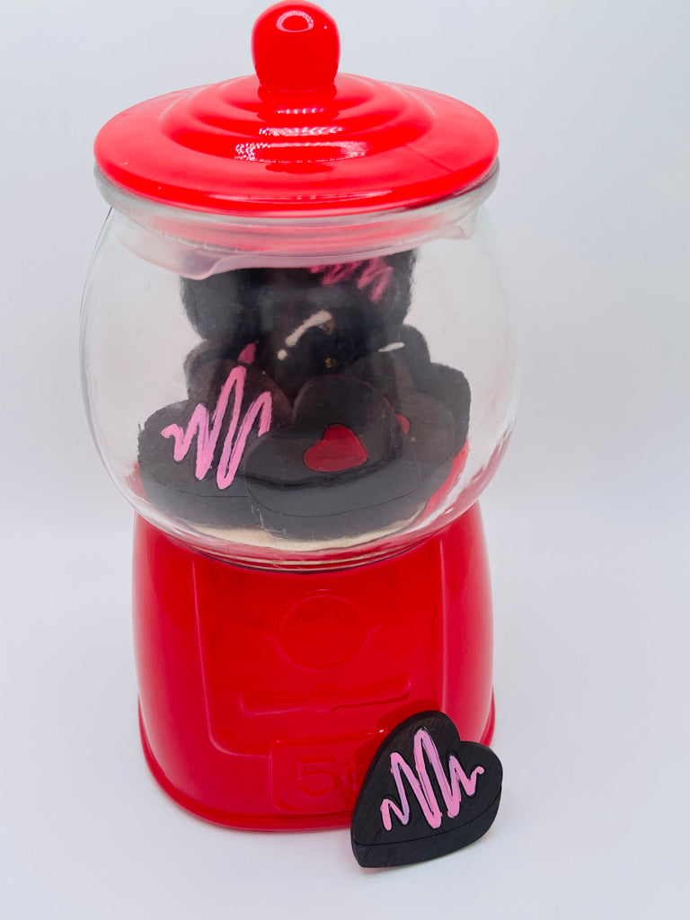 A DIY kit for the Valentine Gumball Machine Filler - DIY Gumball Filler Craft Kit - Wood Blanks by Little August Ranch, with a pink heart on it, filled with candy machine filler.