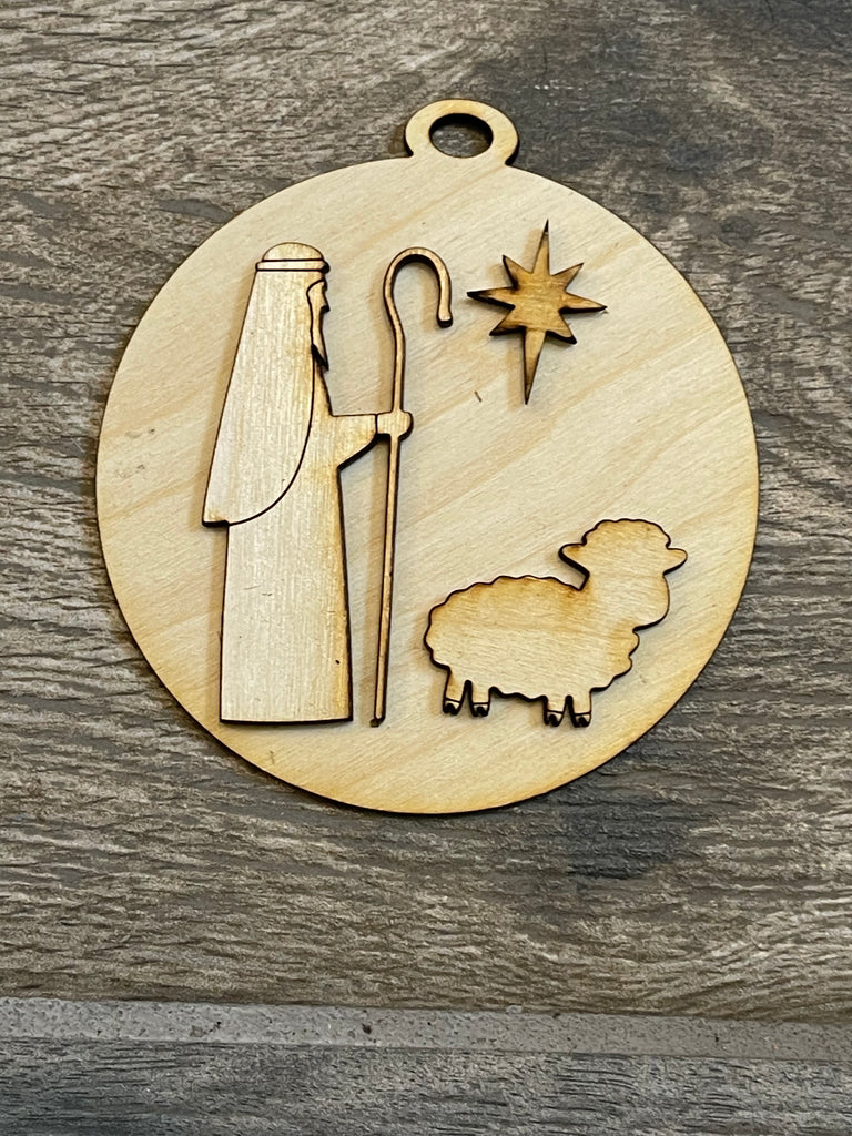 A DIY Little August Ranch wooden Christmas tree ornament featuring a nativity scene with a sheep.