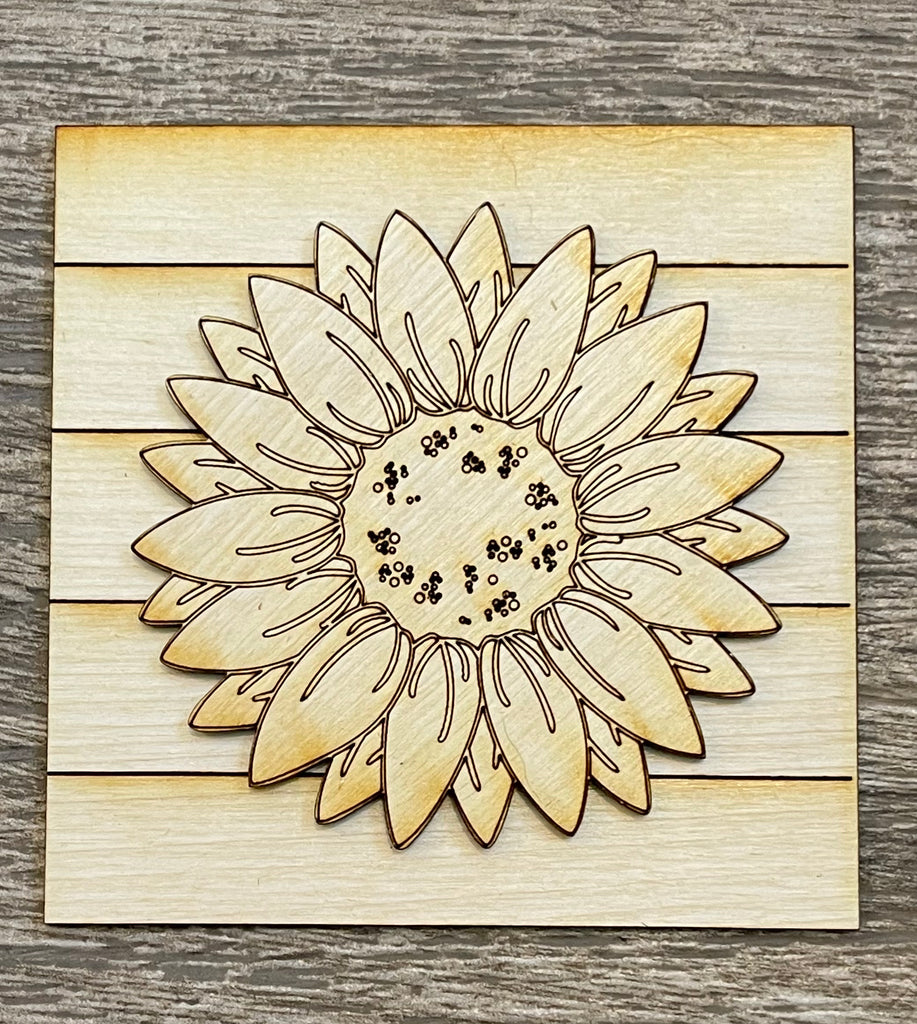 A Little August Ranch DIY kit featuring a laser-engraved sunflower design on wood pieces for tiered trays.