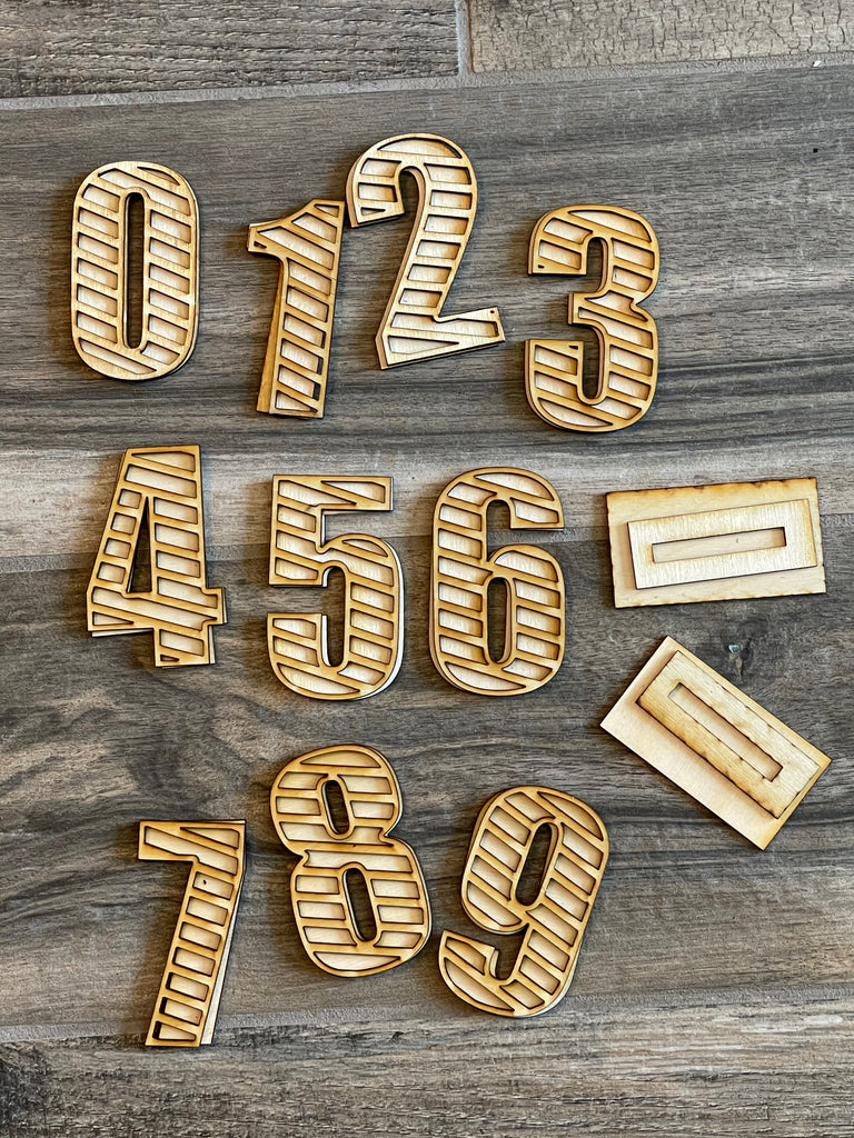 A set of DIY Birthday Tiered Tray Bundle wooden numbers on a wooden table from Little August Ranch.