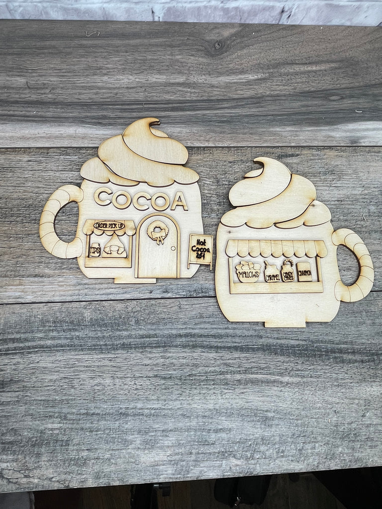 Two Little August Ranch wooden Cocoa Hut decorations designed to look like mugs of hot cocoa, perfect for a Christmas Village display.