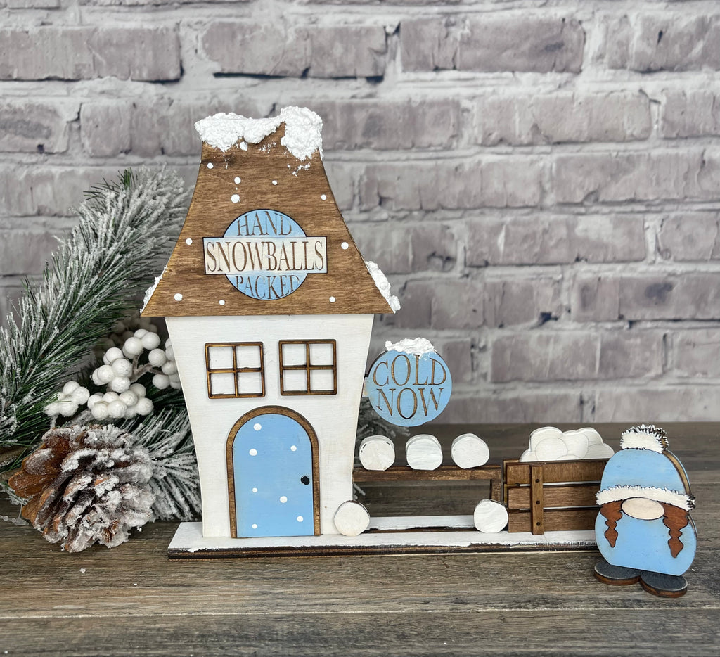 A Little August Ranch Christmas Village with SNOWBALL FACTORY Self Standing Double sided Pieces - Winter Village Wood Blanks, including a wooden house and a snowman.