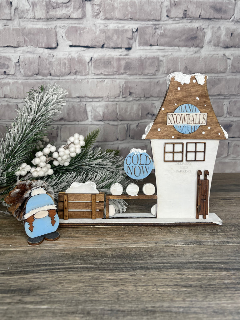 A DIY Little August Ranch Christmas Village house with a snowman.