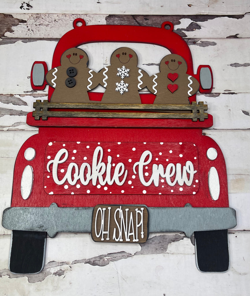 A red and grey sign with Little August Ranch's Gingerbread Insert for Large Interchangeable Truck - Hanging or Self Standing Truck for Interchangeable Pieces in the back of a red truck.
