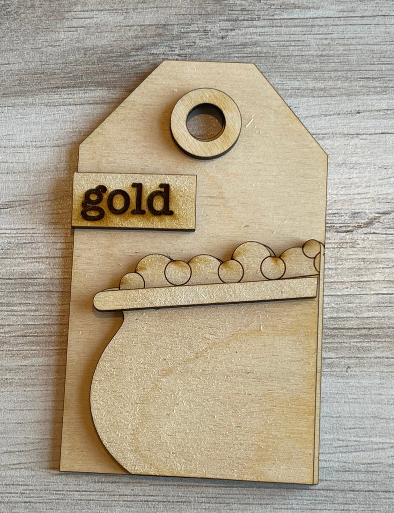 A Little August Ranch DIY St Patrick Tags- Tree Ornament Wood Blank Kit with a wooden tag that has the word gold on it.