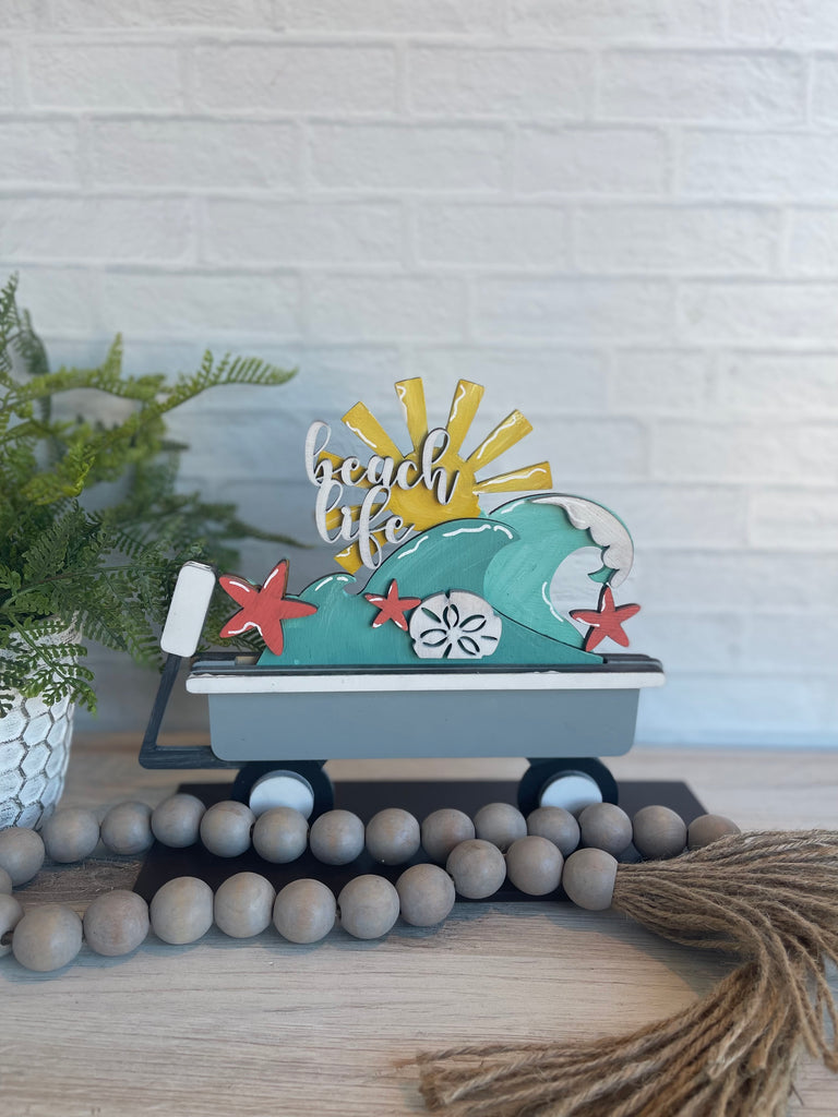 A Little August Ranch beach-themed wooden wagon with the words "beach life" on it, perfect for a tiered tray or as a Beach Wave Insert for Interchangeable Inserts - Unfinished Decor - Freestanding Shelf Decor - Paint it Yourself DIY Kit.