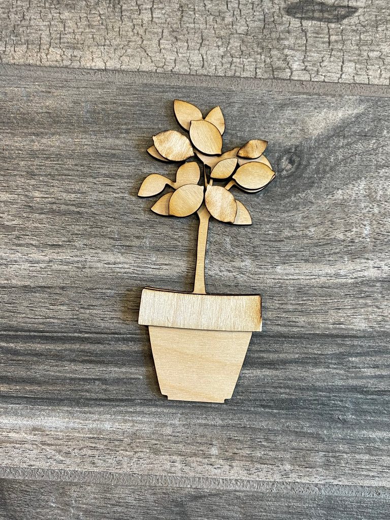 Wooden cutout of a tree in a pot, placed on a gray wooden surface from the Lemon Tiered Tray DIY Paint Kit - Farmers Market Wood Blanks - U-Pick- Summer Paint Kit - Summer Wood Blanks by Little August Ranch.