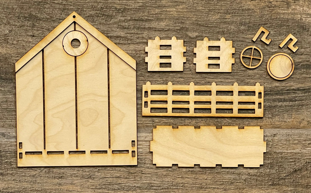 A set of Standing House DIY wooden building pieces on a Little August Ranch wooden surface.