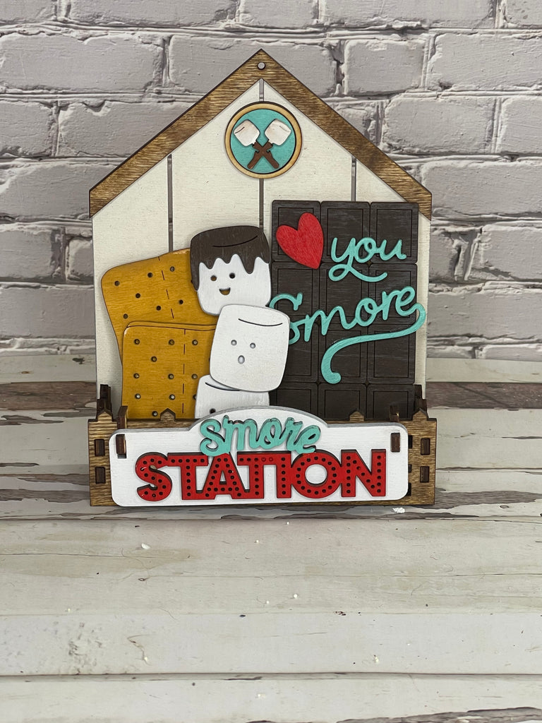 A Little August Ranch wooden sign with a Standing House DIY - Base for Interchangeable Inserts - Tiered Tray Decor - Freestanding Shelf Decor - Paint it Yourself Kit smore station on it.