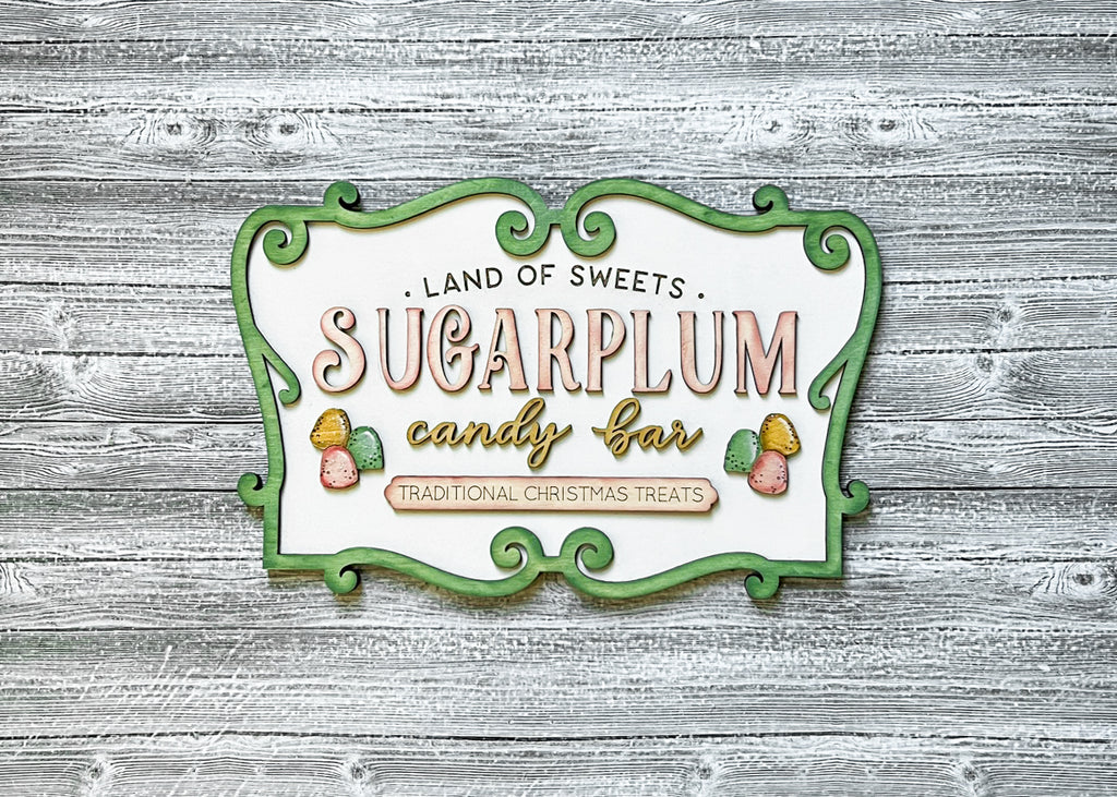 A delightfully festive sign for Little August Ranch's Sugar Plum Candy Shop, featuring a mesmerizing Christmas scene perfect for the DIY Nutcracker Tiered Tray - Sugarplum Christmas Tier Tray Bundle - Tiered Tray Decor Bundle DIY.