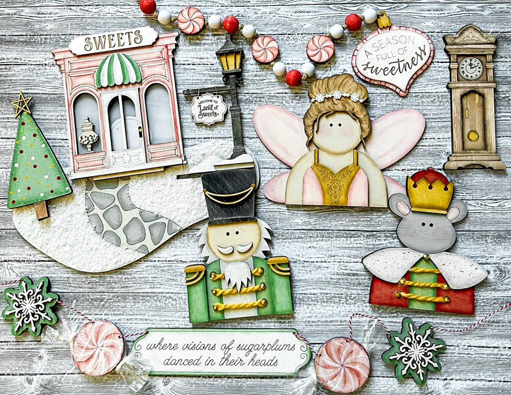 A festive Christmas scene featuring the DIY Nutcracker Tiered Tray - Sugarplum Christmas Tier Tray Bundle - Tiered Tray Decor Bundle DIY by Little August Ranch on a wooden table.